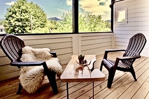 Private deck with outdoor furniture and hammock.